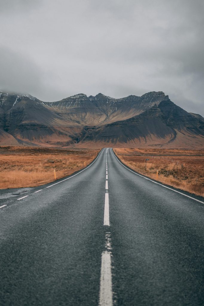 pexels-photo-1955134-1955134 A scenic empty road stretches into snow-capped mountains under cloudy skies, offering a sense of adventure and tranquility.