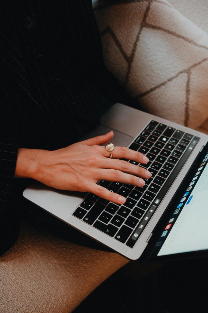 pexels-photo-32341954-32341954 A close-up view of a person typing on a laptop keyboard with a focused hand.